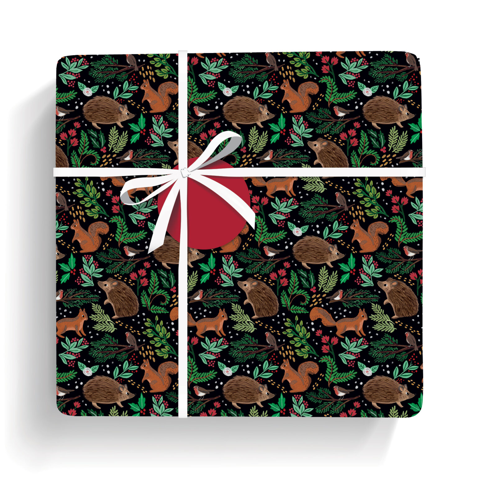 Gift wrapped in this black paper featuring woodland animals, festive leaves, and berries; tied with white ribbon and red gift tag.