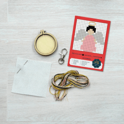 Contents of this product including embroidery hoop, keyring, fabric, needle, thread, and angel pattern