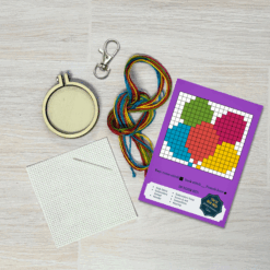 Contents of this product including embroidery hoop, keyring, fabric, needle, thread, and colourful balloons pattern