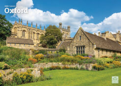 Front cover of this 2026 Calendar of Oxford featuring stone buildings and vibrant gardens, beneath a bright blue sky with scattered clouds.