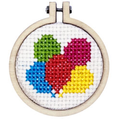 Close up of the finished mini cross stitch colourful balloons in embroidery hoop