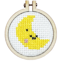 Close up of the finished mini cross stitch crescent moon in embroidery hoop
