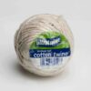 Medium ball of cotton twine with product label showing 525m per kg and minimum 85% cotton content.