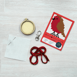 Contents of this product including embroidery hoop, keyring, fabric, needle, thread, and robin pattern
