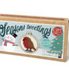 Cross stitch mini kit box featuring a festive robin design in a small embroidery hoop, with snowman, Christmas tree, and snowflake background. Text reads “Seasons tweetings” and “Keyring included.”