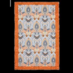Tea towel with bright orange border and block pattern of birds, butterflies, leaves and flowers in orange, blue and white.