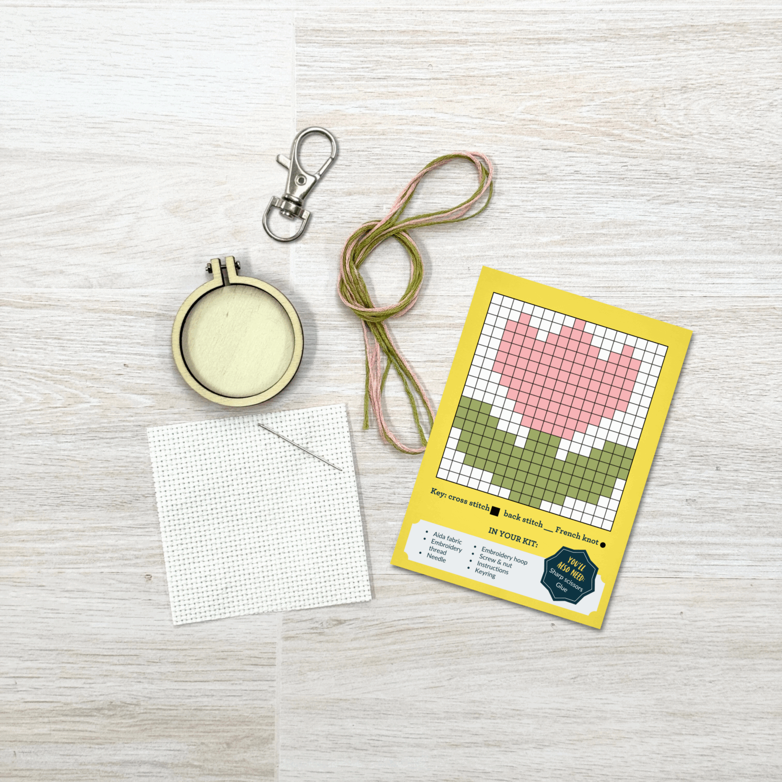 Contents of this product including embroidery hoop, keyring, fabric, needle, thread, and flower pattern