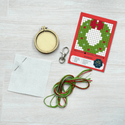 Contents of this product including embroidery hoop, keyring, fabric, needle, thread, and wreath pattern