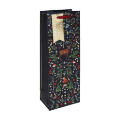 A navy Christmas bottle gift bag with pattern of trees, woodland animals and foliage. A gold tag is attached.