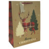 A Christmas gift bag which is kraft brown with a silhouette of a tartan stag next to trees. Text reads Merry Christmas. The bag has red handles and a silver gift tag.
