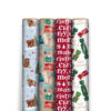Four Christmas wrapping paper rolls featuring images on each one with Highland cows, one with gift boxes, one with “Merry Christmas” text and lastly with Christmas crackers printed on the roll.