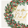 hristmas card with a pine wreath decorated with red and pink berries and gold accents, set against a light beige speckled background. Features the message “Mum & Dad With Love at Christmas” in elegant script.