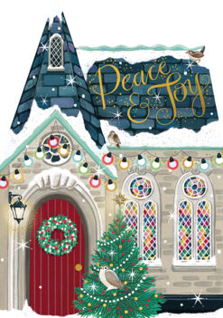 Christmas card featuring a snow-covered cut-out chapel with a red door, green wreath, stained glass windows, and festive string lights. A decorated tree and perched birds add charm, with 'Peace & Joy' written above in elegant gold script.