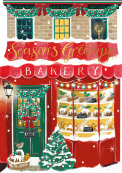 Christmas card showing a bakery storefront decorated with wreaths, garlands, and lights. The window displays festive treats like mince pies and gingerbread, with a red 'Season’s Greetings' sign above and a green door with a wreath and bow.
