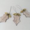Wooden holly shaped decoration with gold leaves and bells. The decoration has a string hanging loop.