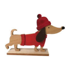 A wooden decoration in the shape of a sausage dog wearing a red jumper and red woolly hat.