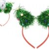 A red hair band topped with two tinsel Christmas trees which have pom pom decorations and a start on top.