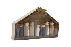 A wooden nativity scene with stable and seven figures.