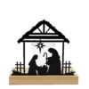 A wooden and iron candle holder featuring the nativity scene and a glass to hold a tealight.