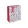 A white gift bag decorated with colourful flowers, pink side panels, and a pink braided handle with tag.