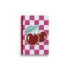 A5 notebook with pink and white square checked pattern and two large sparkly cherries. The book has a red spine.
