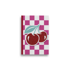 A5 notebook with pink and white square checked pattern and two large sparkly cherries. The book has a red spine.