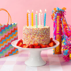 Colourful birthday cake showcasing Bobble candles and party decorations.