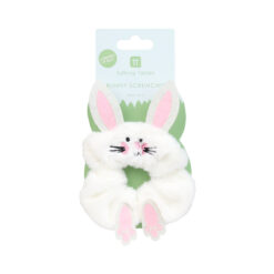 A white fluffy hair scrunchie designed as a bunny, featuring soft ears, an embroidered face and small pink feet, displayed on packaging labelled ‘Bunny Scrunchie'.