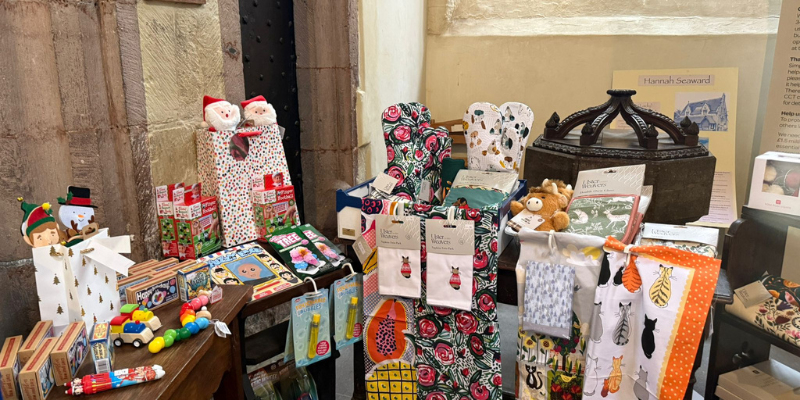 Gift items, gift bag and homeware items on display inside St Martin's Church, Exeter.