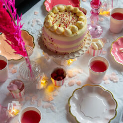 A pink and white party table setup showcasing heart‑shaped confetti.