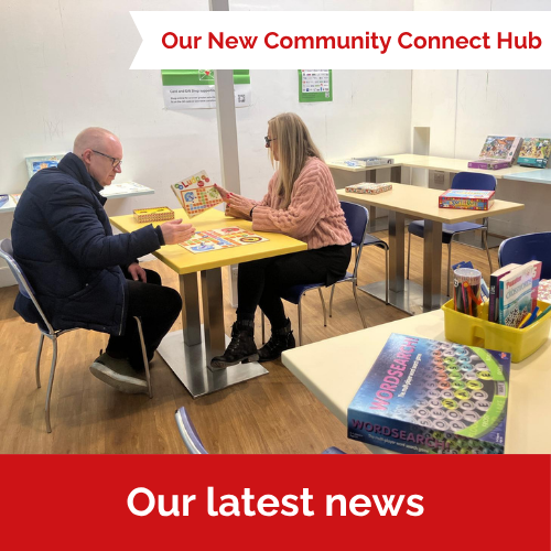 Our New Community Connect Hub. Image shows a man and woman sitting at a table playing games.
