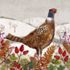 Illustration of a pheasant with rich brown feathers and a red face standing in a snowy field surrounded by red berries, ferns, and bare trees under gentle snowfall.