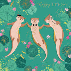 Square card with a green background. Three otters float on their backs while holding paws. They are surrounded by water lilly pads and pink flowers. Gold text at the top reads 'happy birthday'.