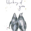 Watercolour illustration of two penguins walking side by side, one holding a small flower, with handwritten text ‘Thinking of you’ surrounded by tiny gold stars